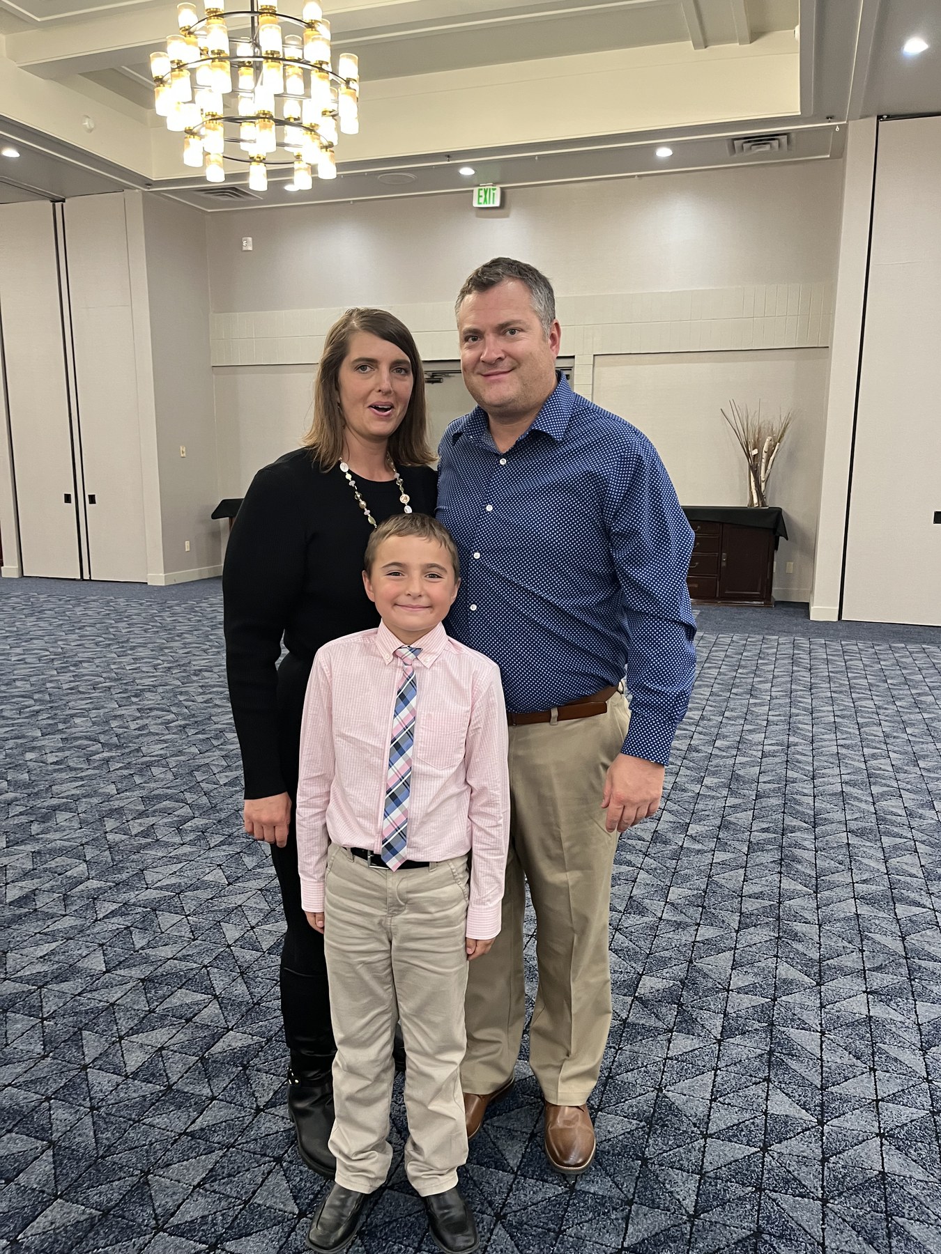 Jeff and Janica DeJuncker standing with their son, Jack.